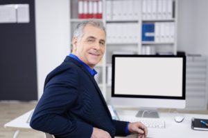 Older man at computer in office